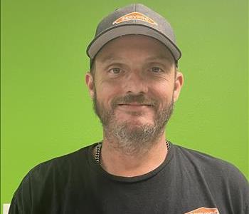 upbeat middle age Caucasian male, wearing a Servpro Cap